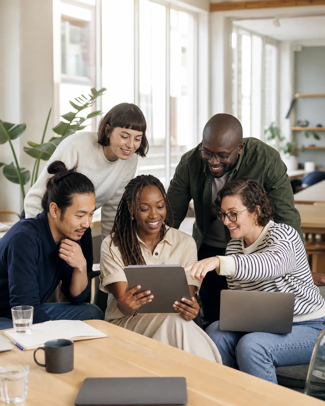 A diverse team enjoying technology together